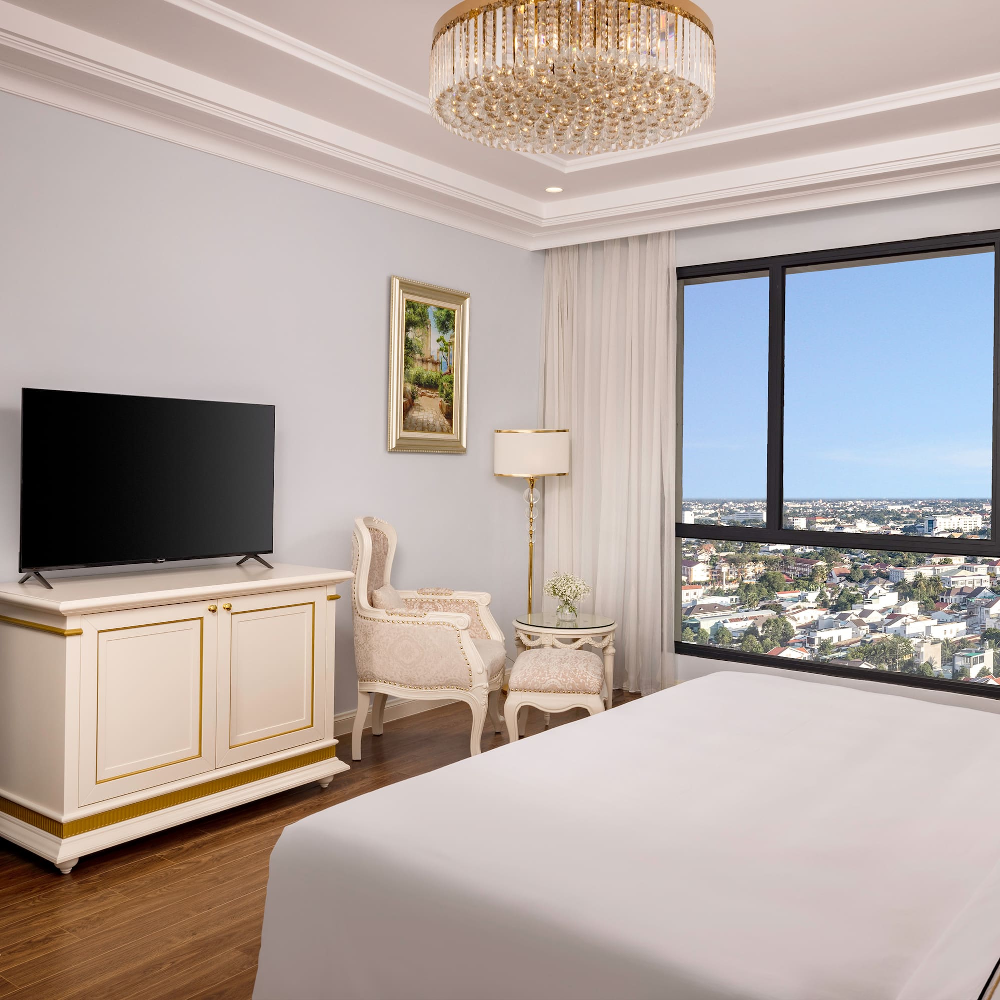 a bedroom with a large television and a large window