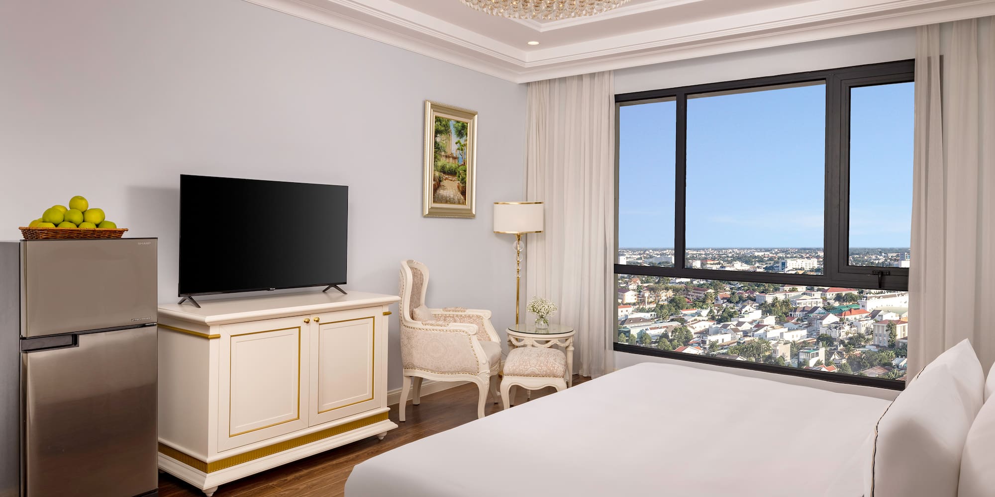 a bedroom with a large television and a large window