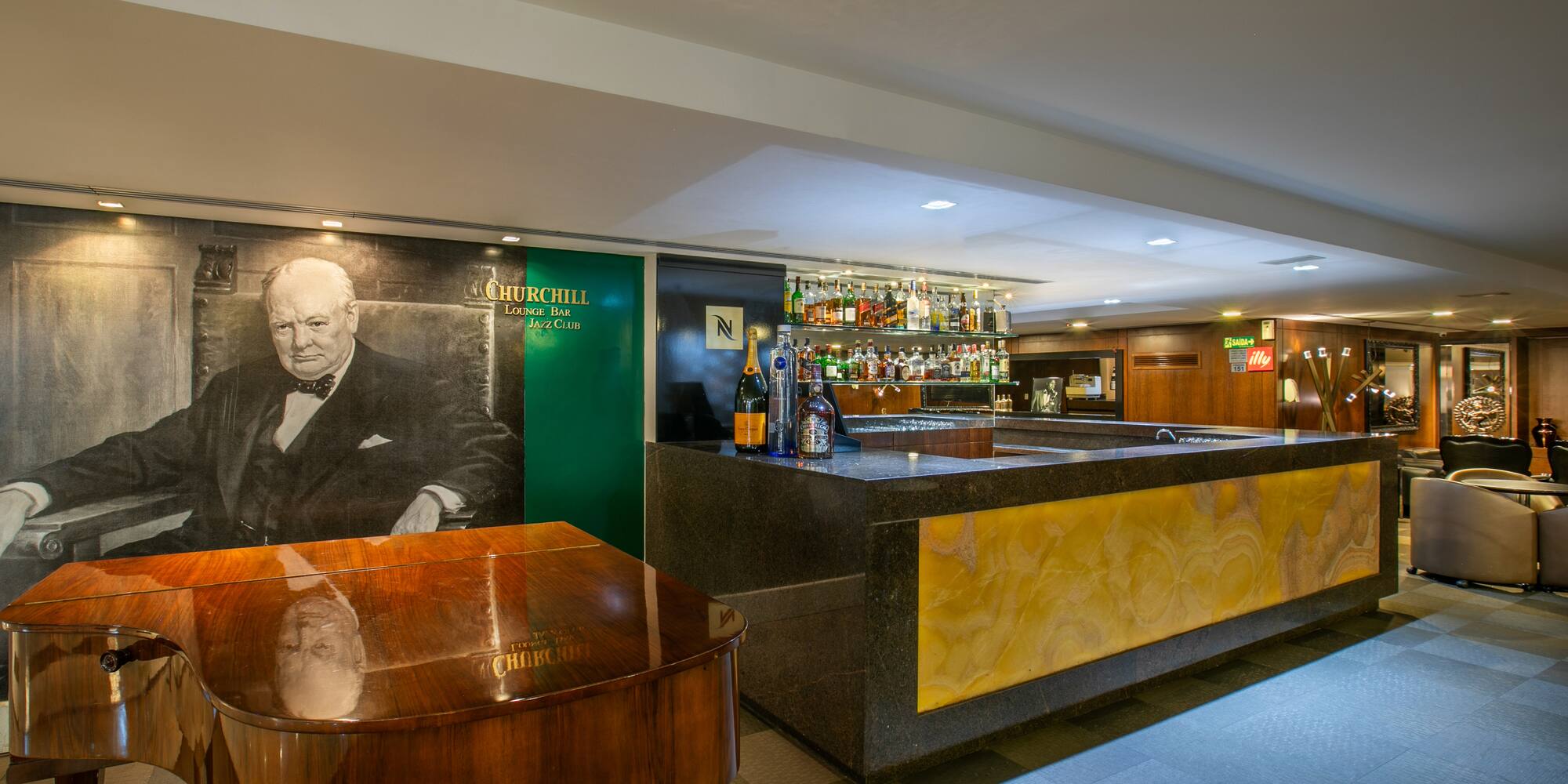 Churchill Lounge Bar Jazz Club interior with a grand piano and full bar.