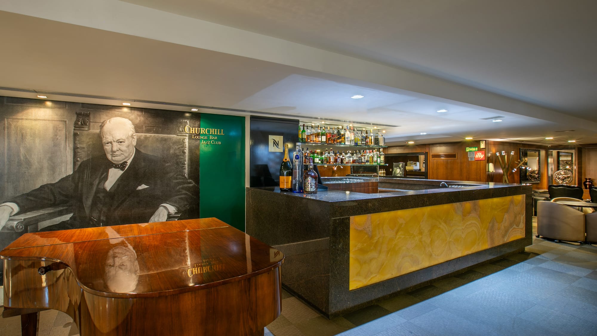 Churchill Lounge Bar Jazz Club with Churchill mural, grand piano, and bar.