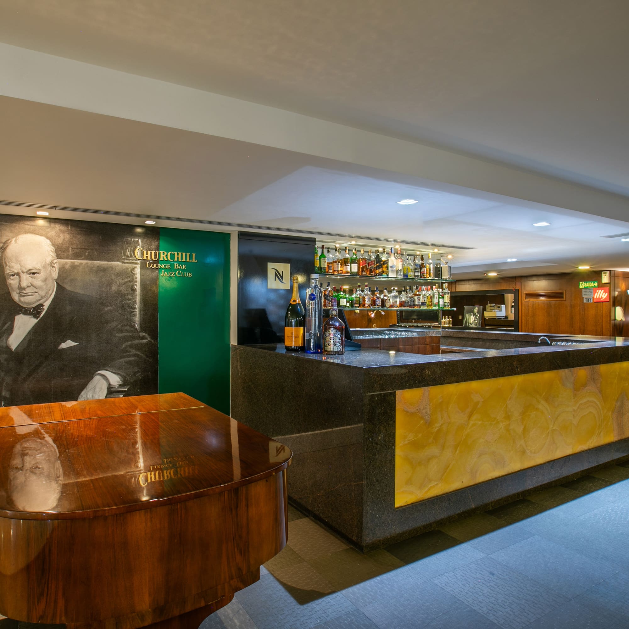 Churchill Lounge Bar Jazz Club with Churchill mural, grand piano, and bar.