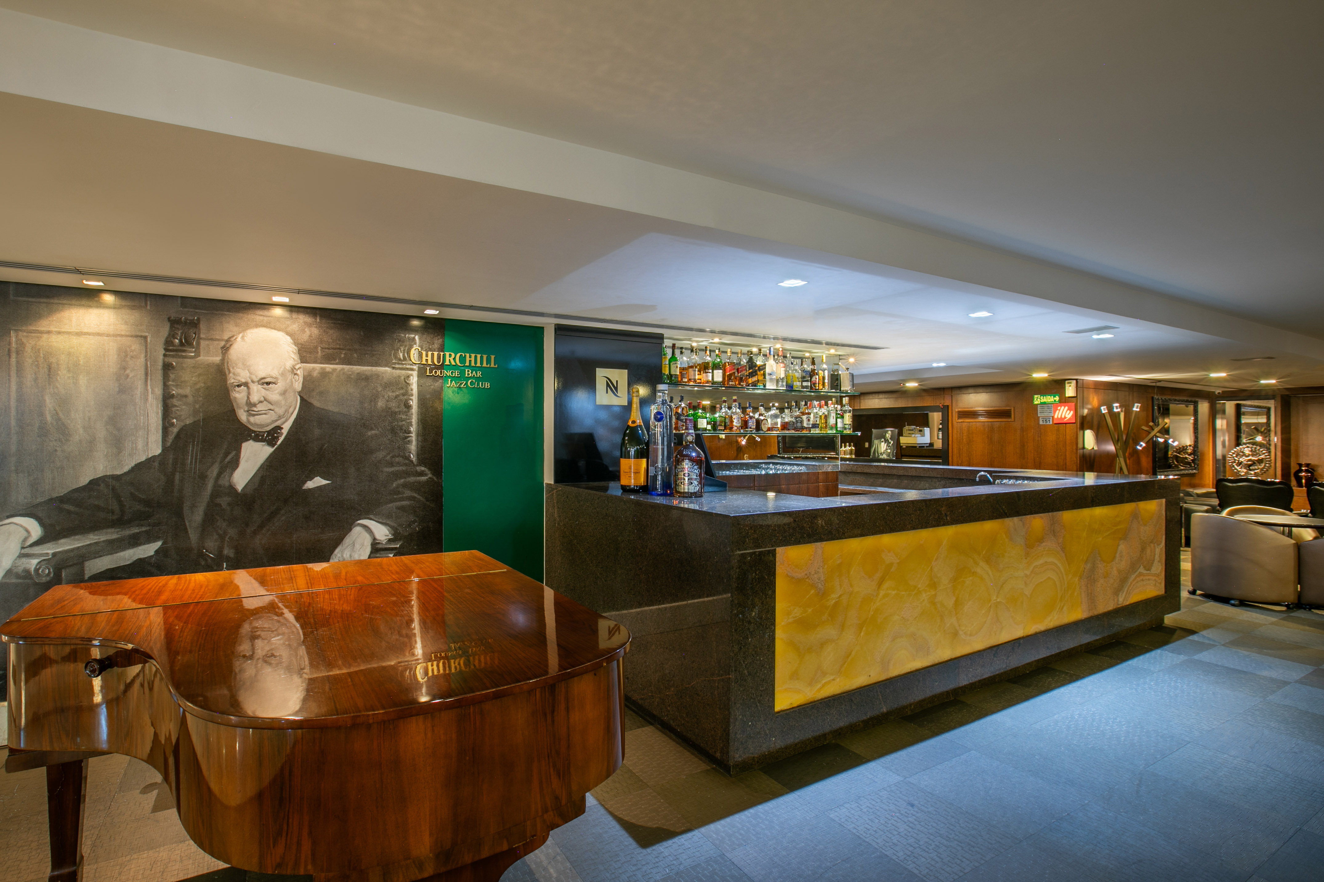 Churchill Lounge Bar Jazz Club with Churchill mural, grand piano, and bar.