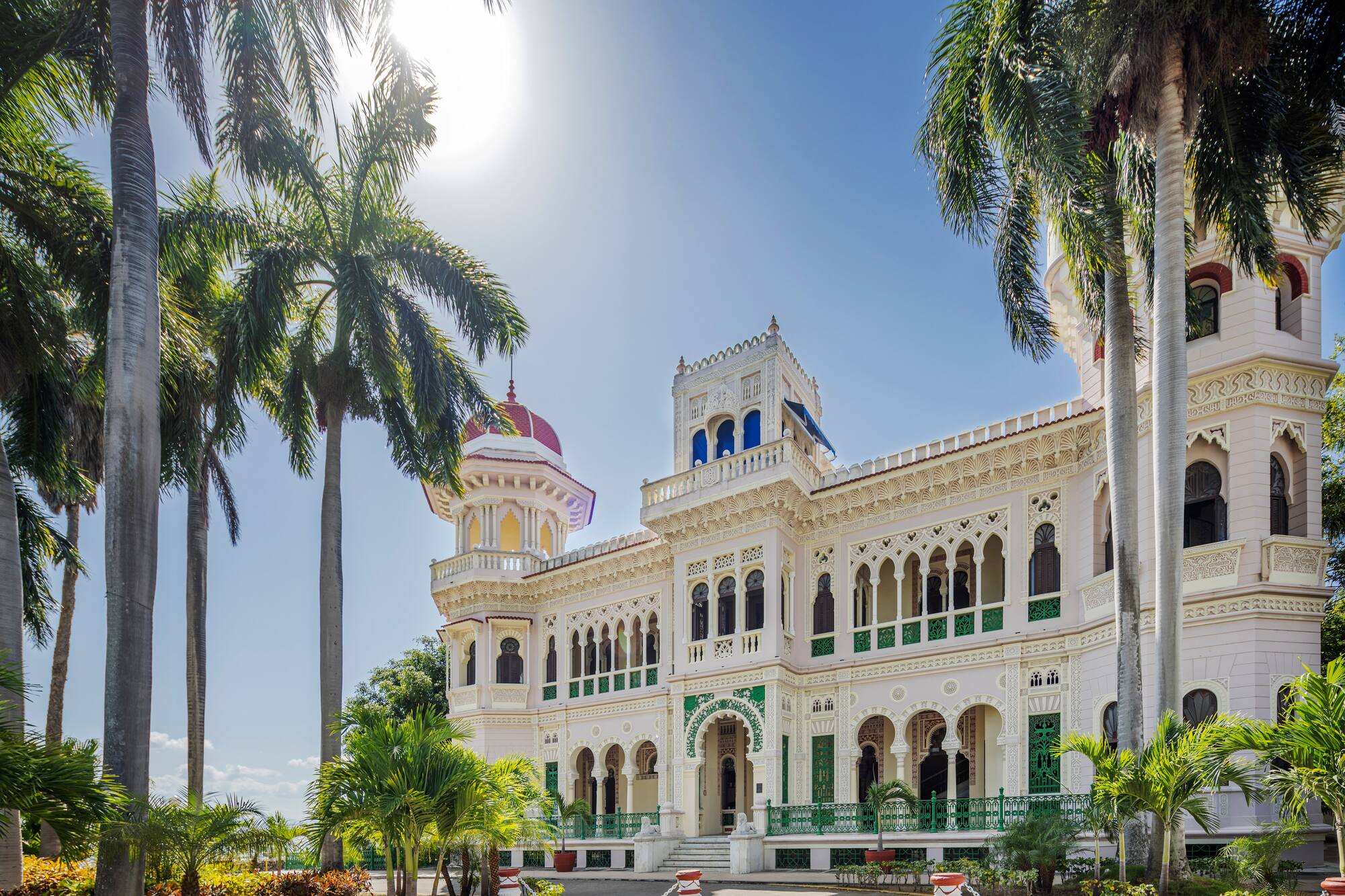 a large white building with palm trees