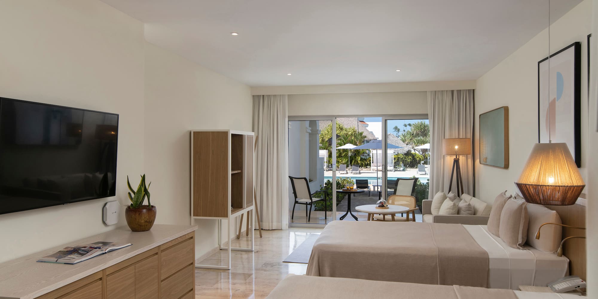 a room with two beds and a television