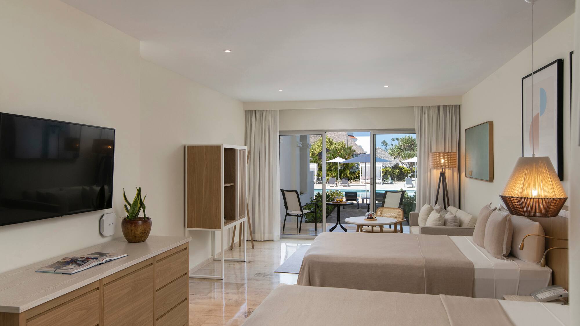 a room with two beds and a television