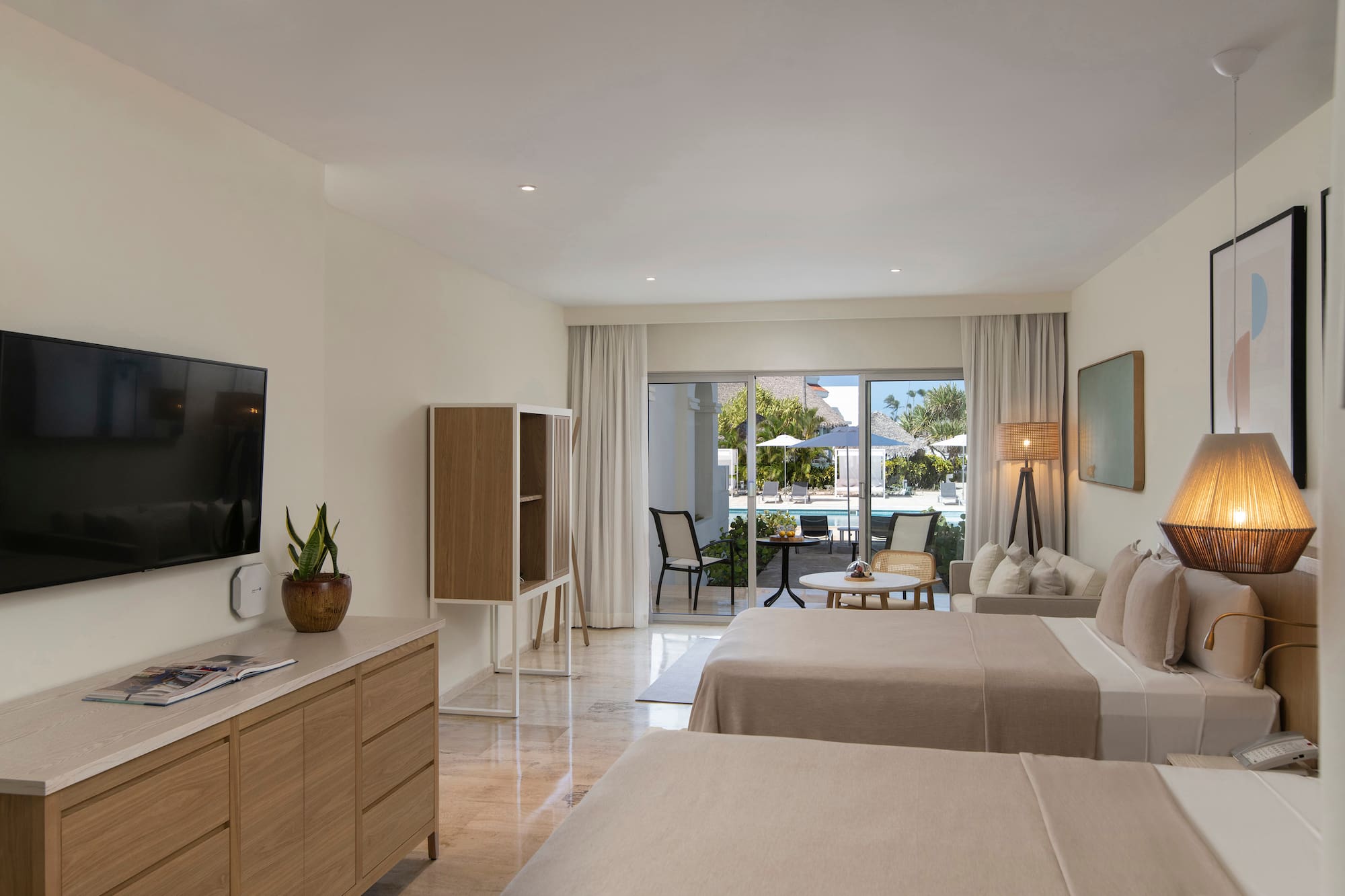 a room with two beds and a television