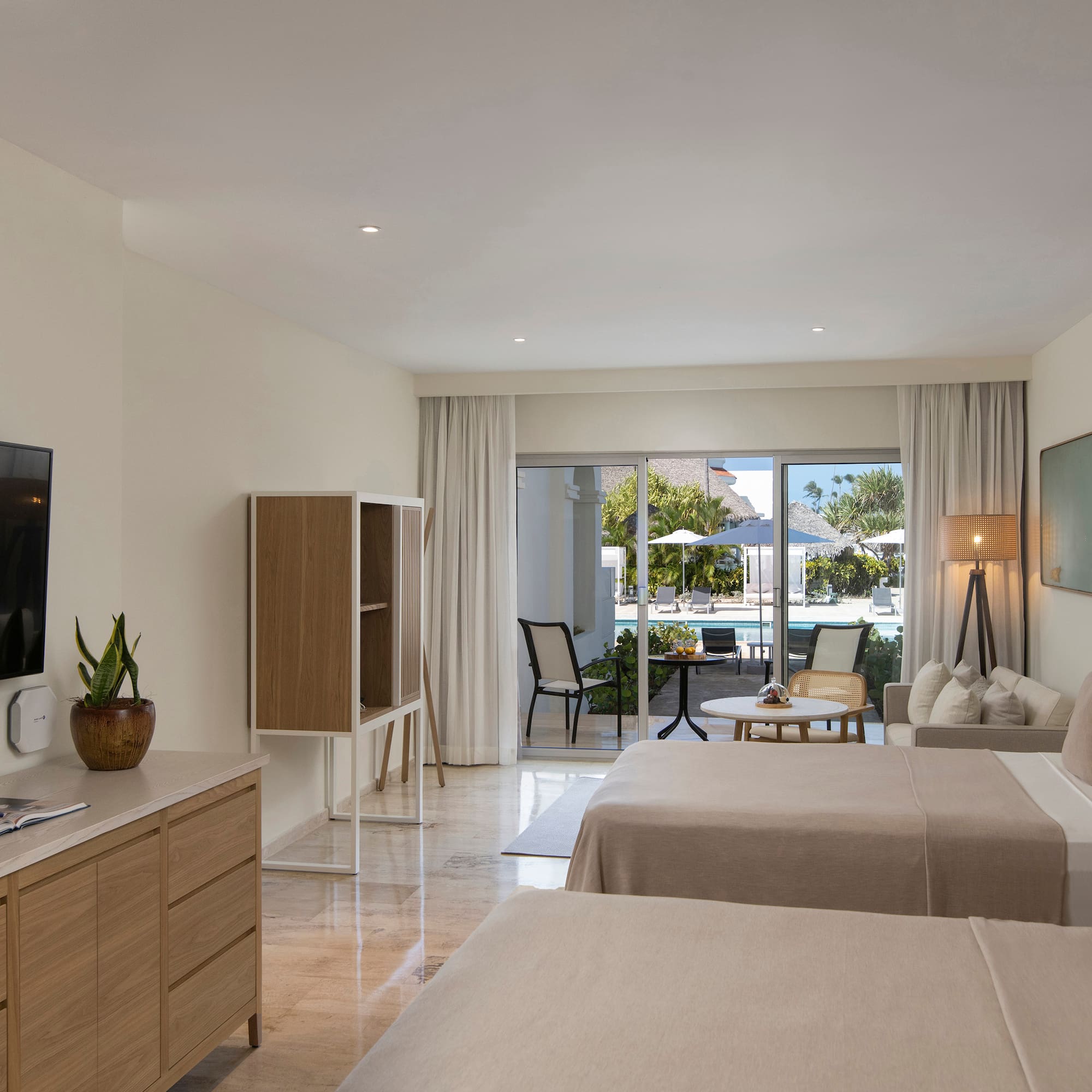 a room with two beds and a television