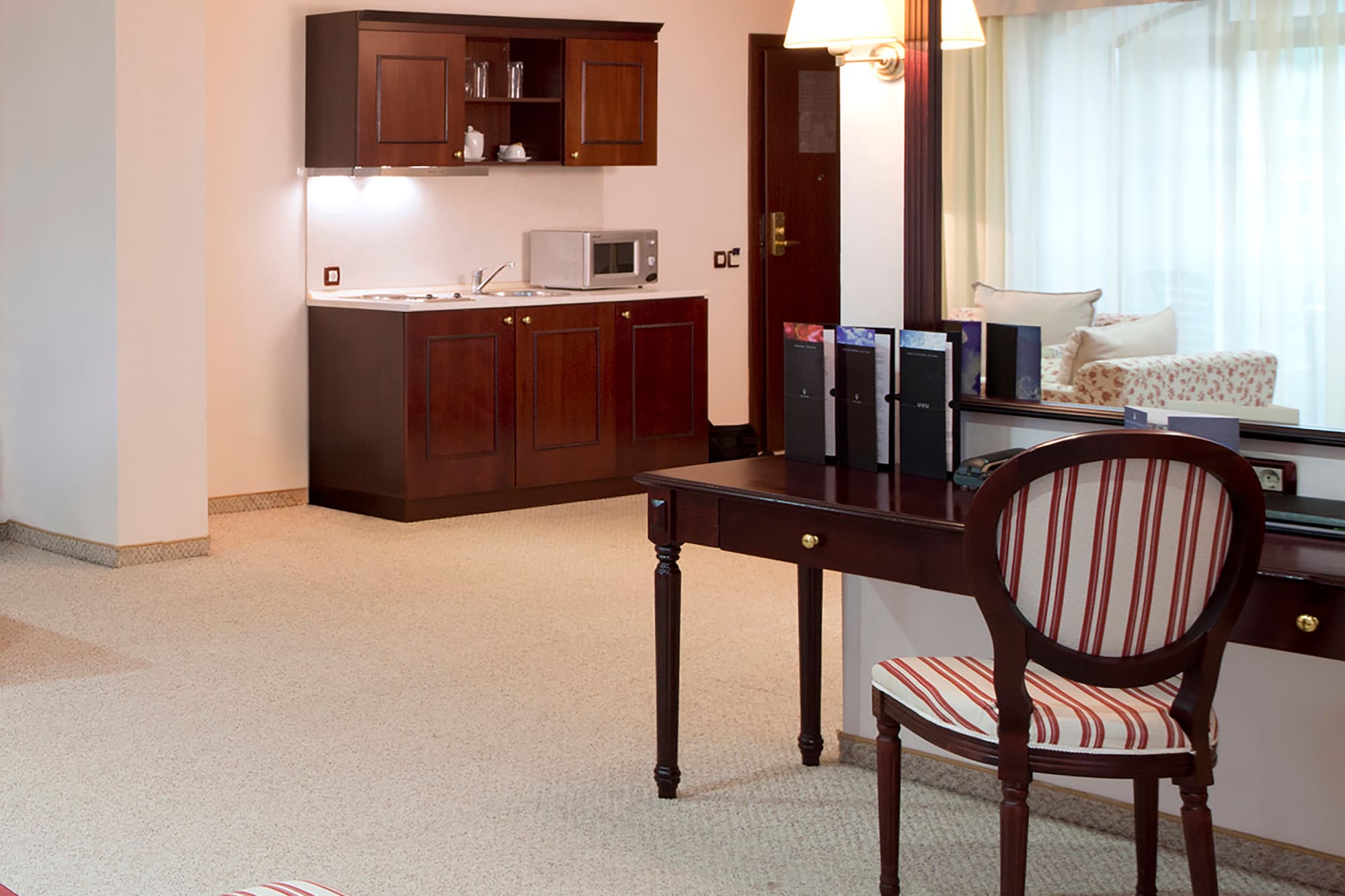 a room with a mirror and a desk