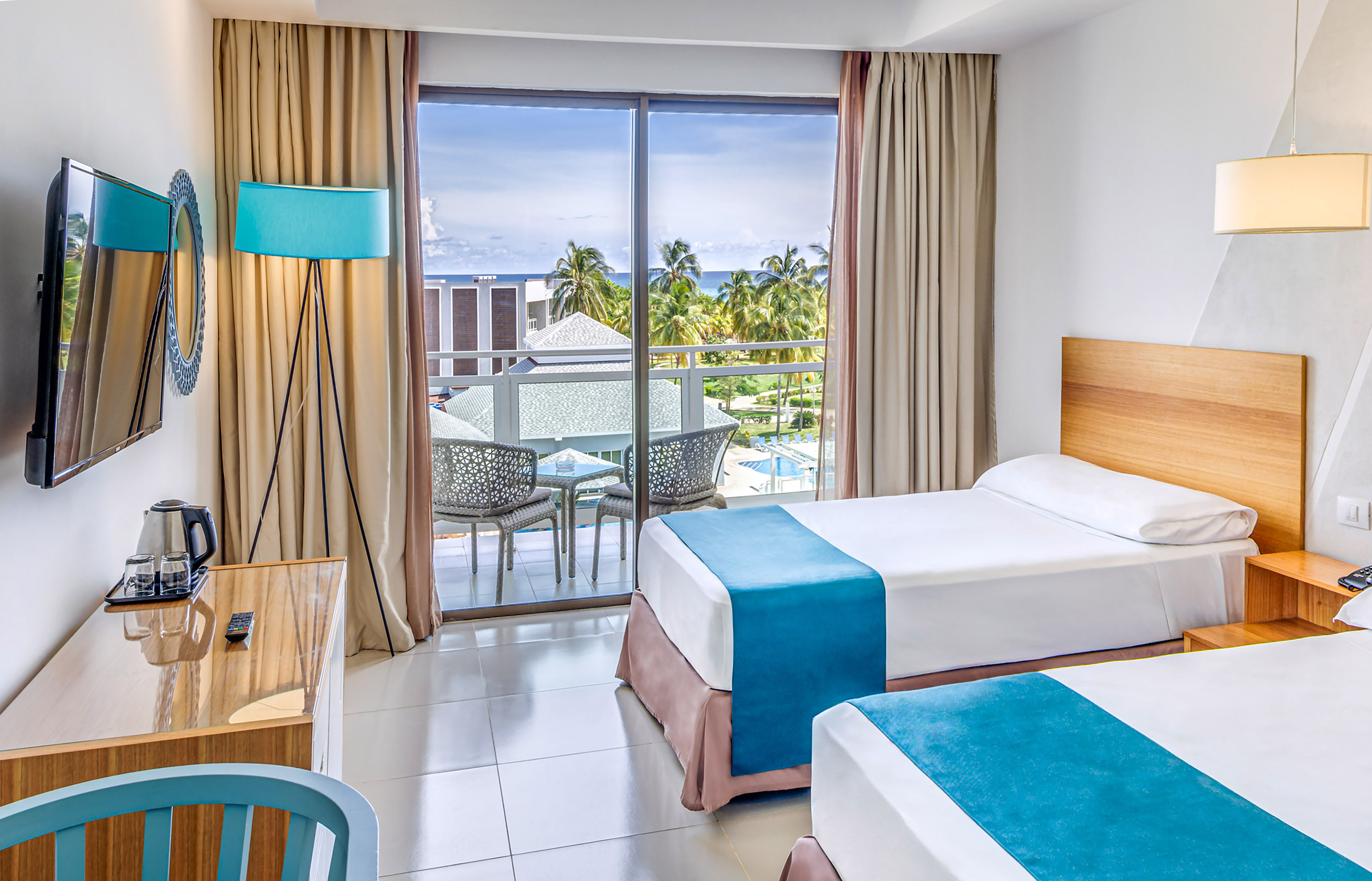 a room with two beds and a desk