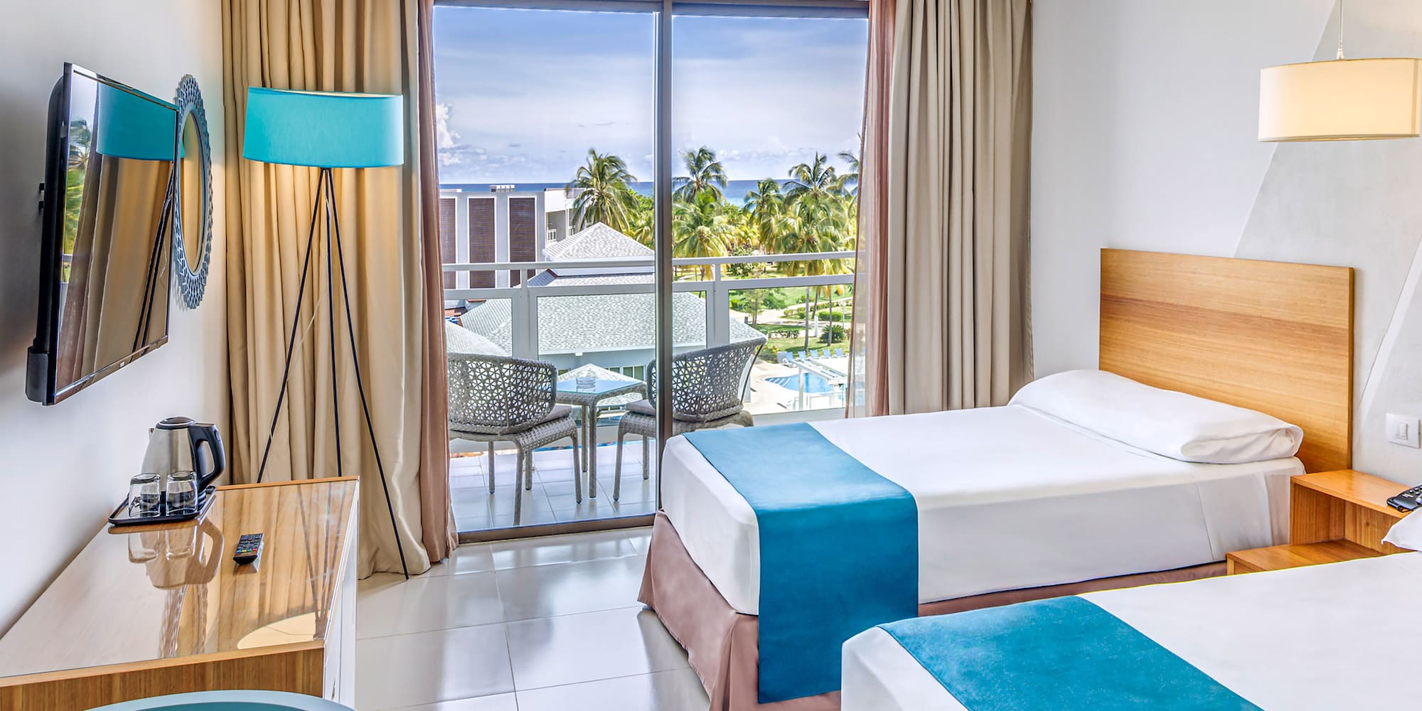 a room with two beds and a desk