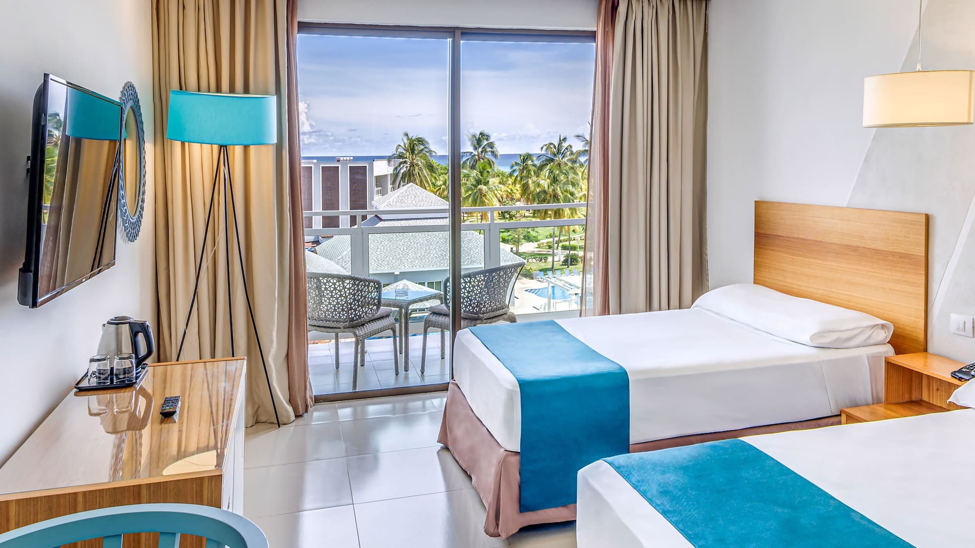 a room with two beds and a desk