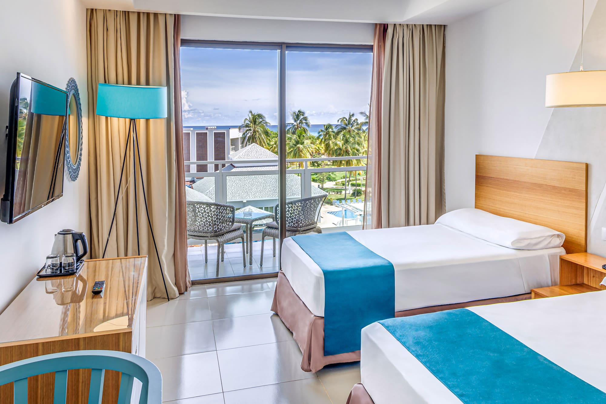 a room with two beds and a desk