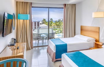 a room with two beds and a desk