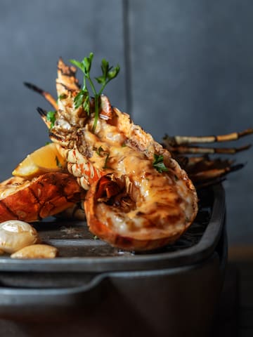 a cooked shrimp with lemon and garlic on a pan