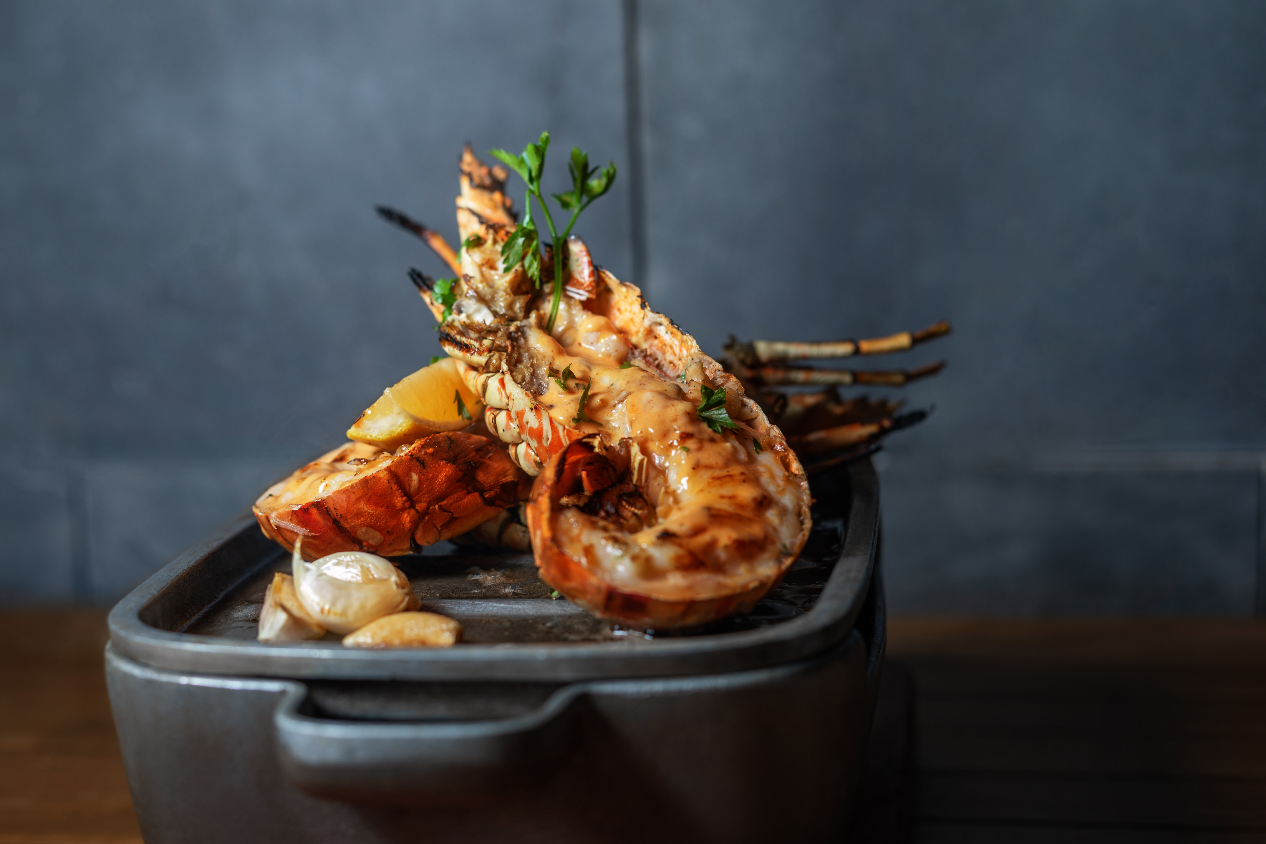 a cooked shrimp with lemon and garlic on a pan