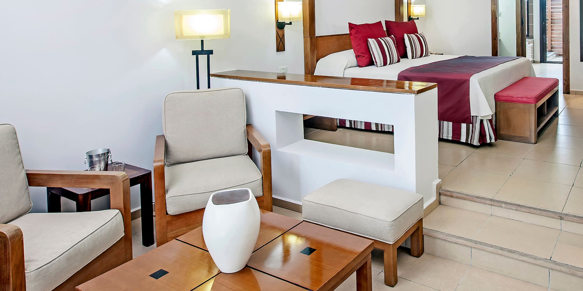 a room with a bed and chairs