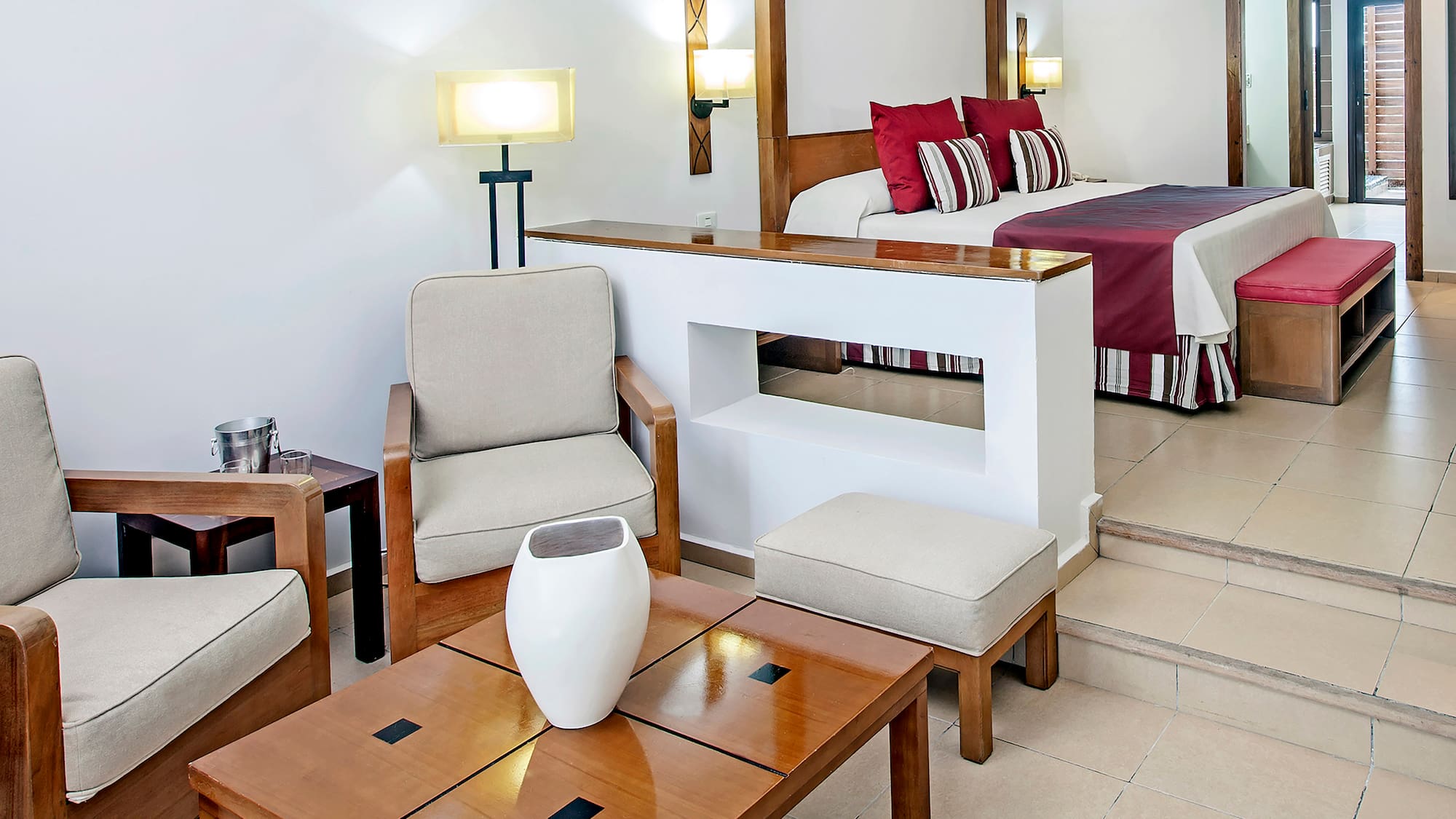 a room with a bed and chairs