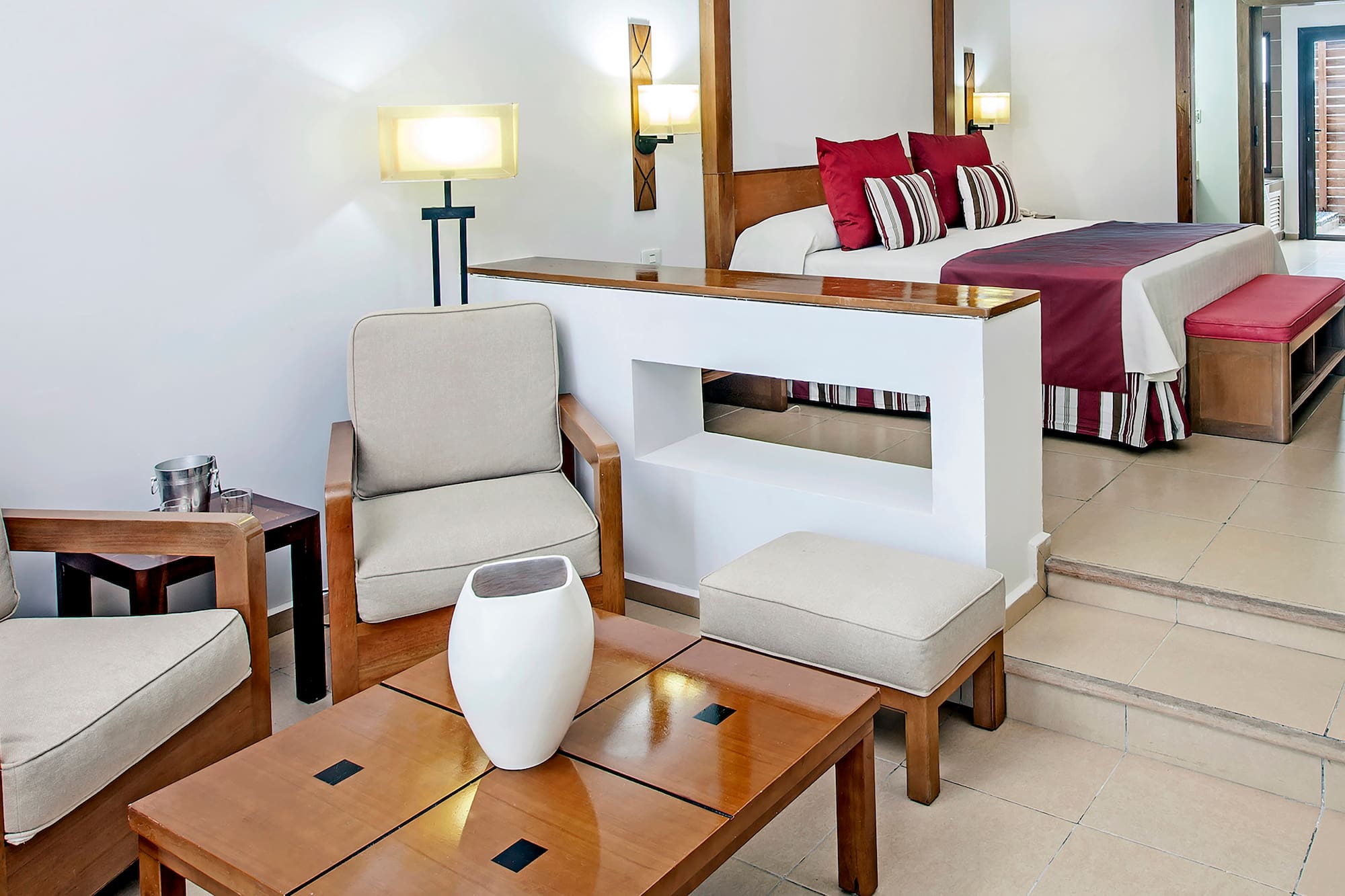 a room with a bed and chairs