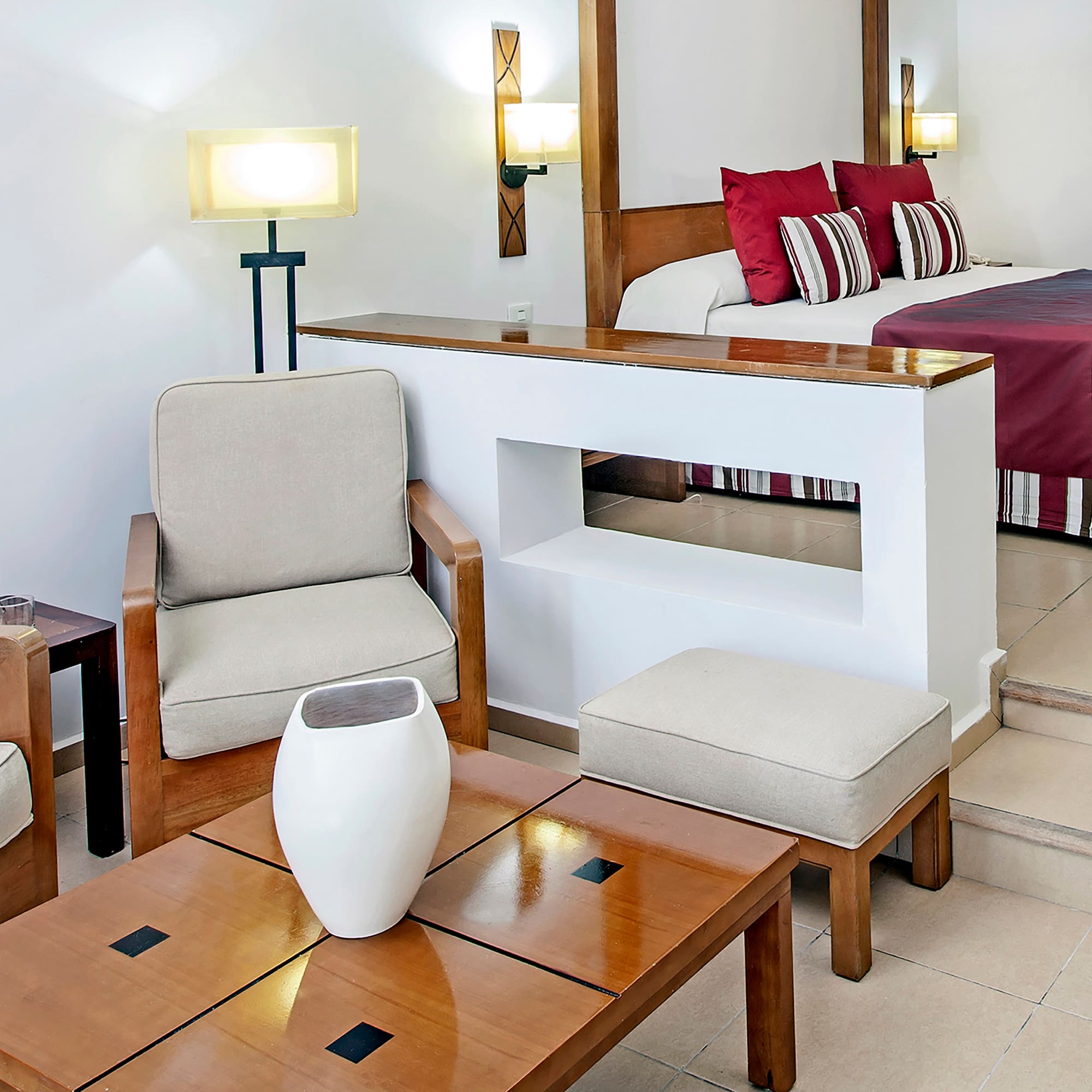 a room with a bed and chairs