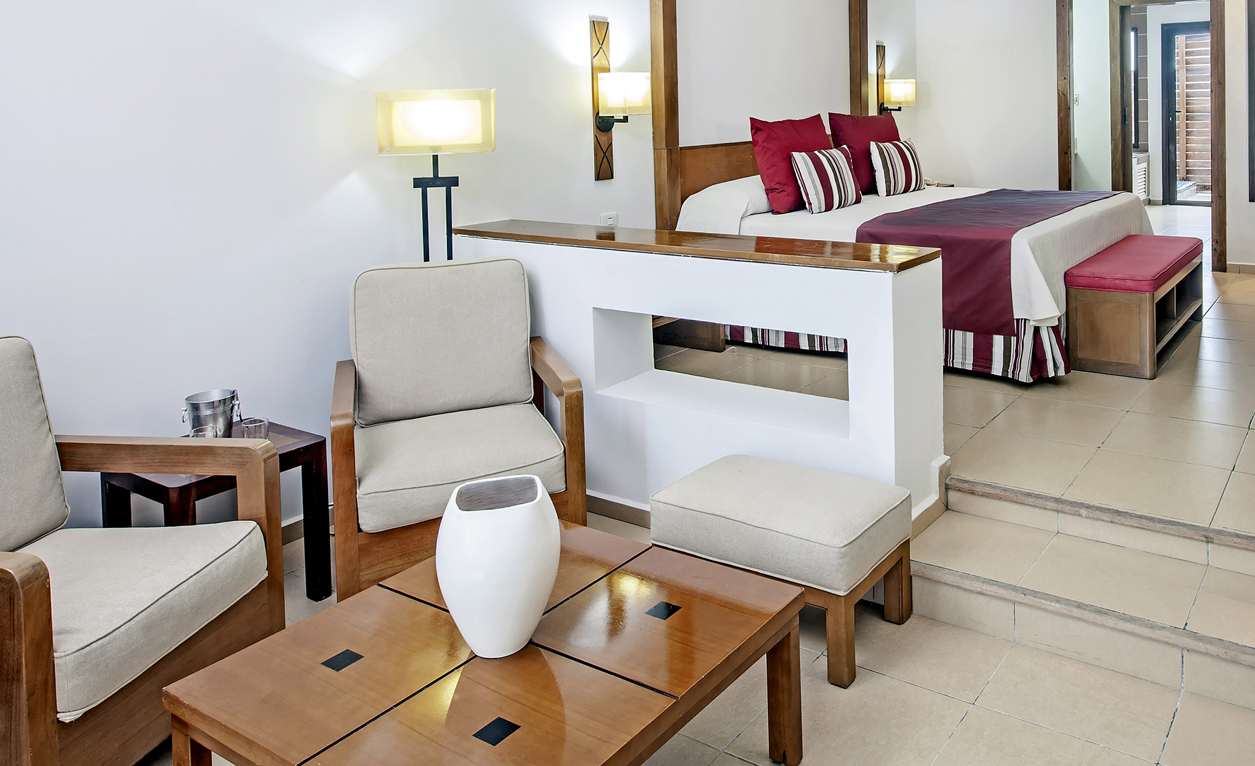 a room with a bed and chairs