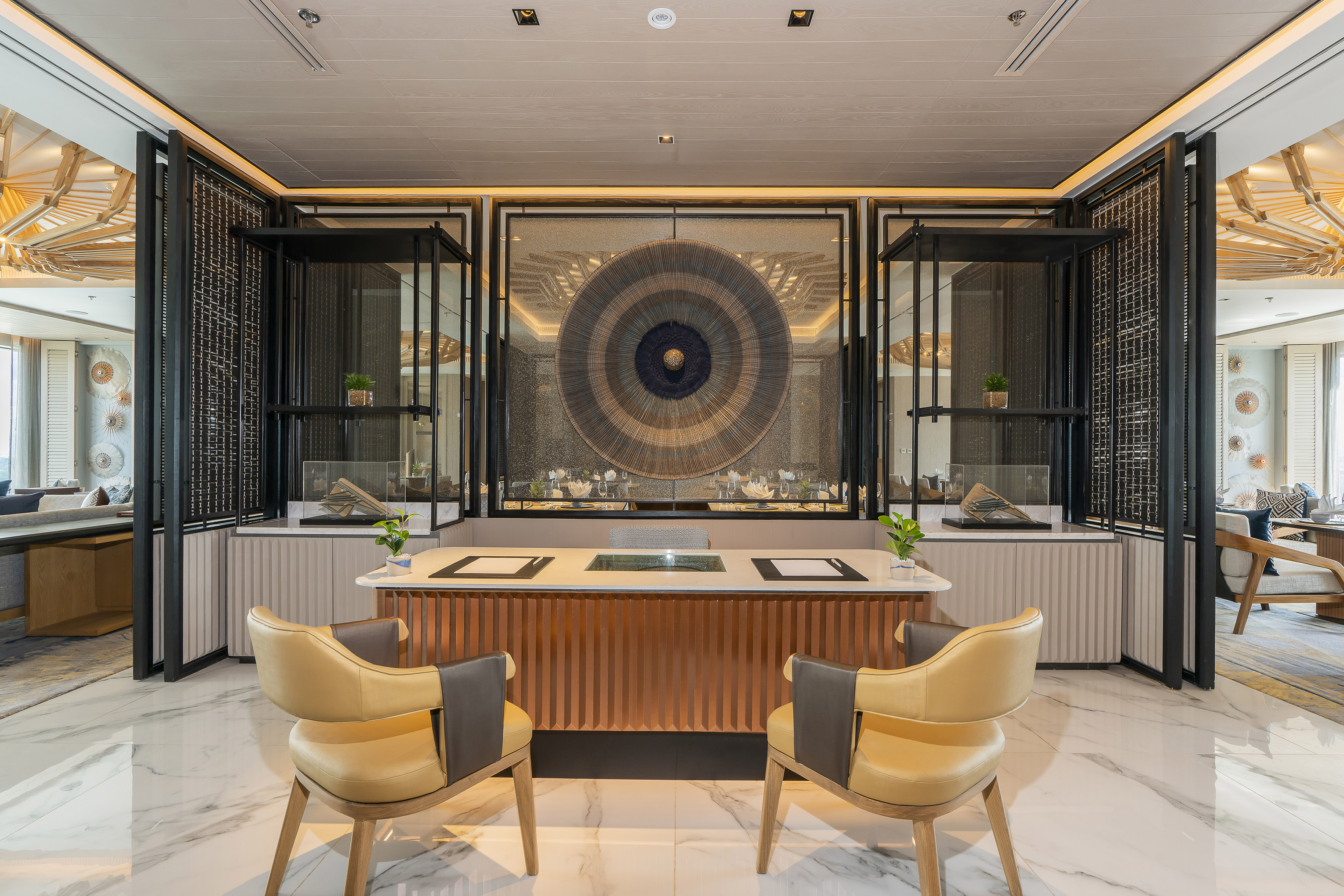 Let yourself be carried away by a world of distinction and exclusive amenities a room with a table and chairs