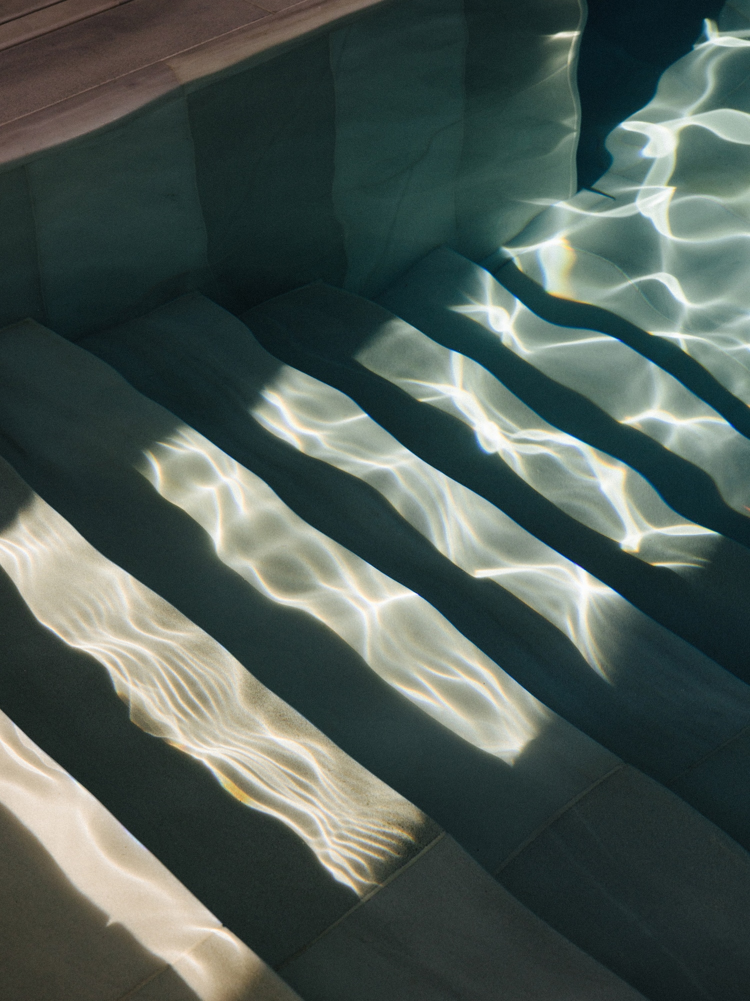 a stairs under water with sunlight shining on them