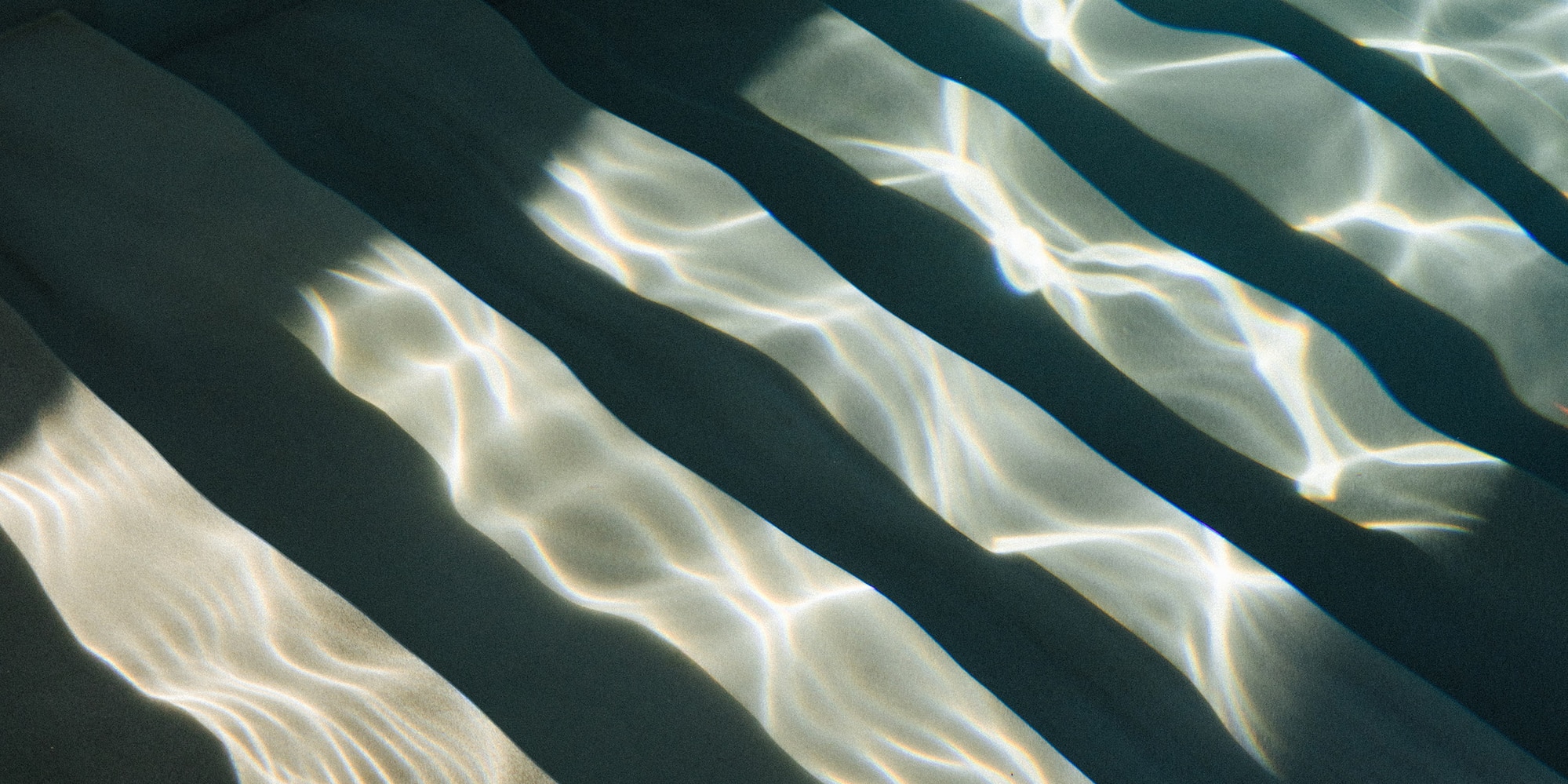a stairs under water with sunlight shining on them