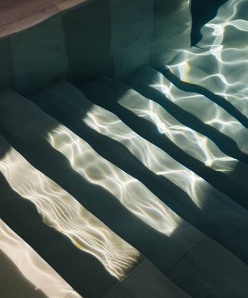 a stairs under water with sunlight shining on them