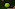 Slazenger Wimbledon tennis ball on a green grass court with striped deck chairs.