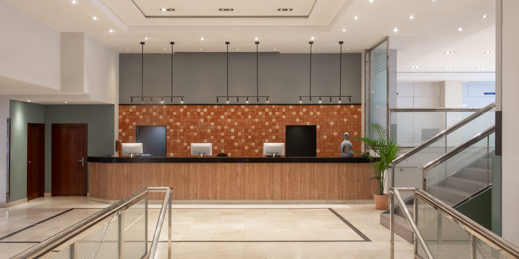 a lobby with stairs and a counter