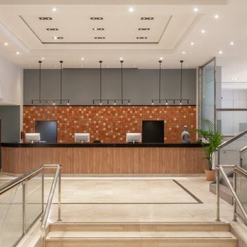 a lobby with stairs and a counter