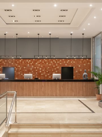 a lobby with stairs and a counter
