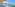 Resort infinity pool, ocean view, desert, lounge chairs, palm trees.