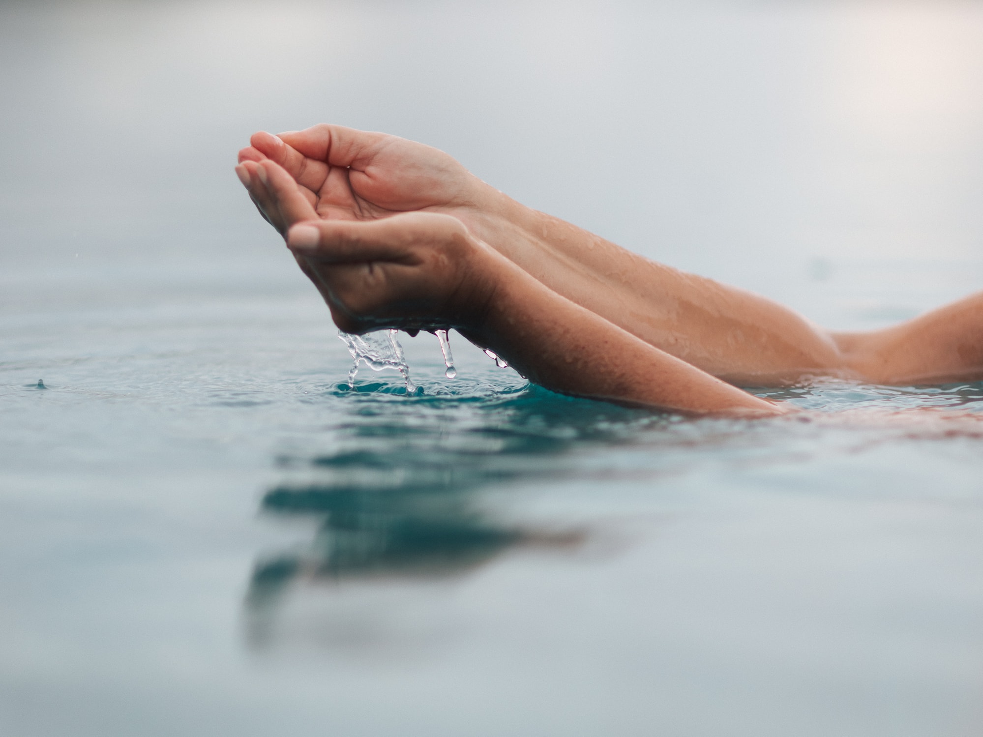 a person's hands in water