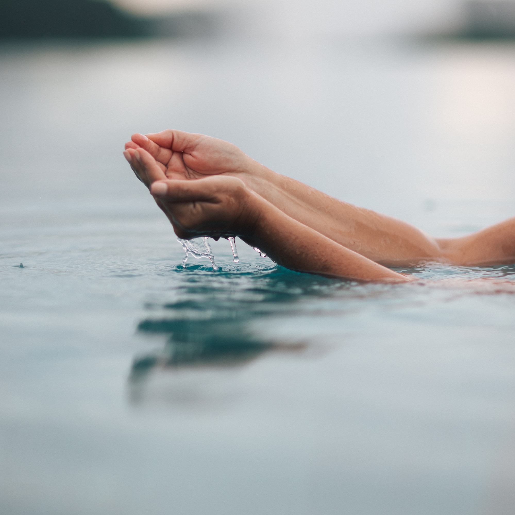 a person's hands in water