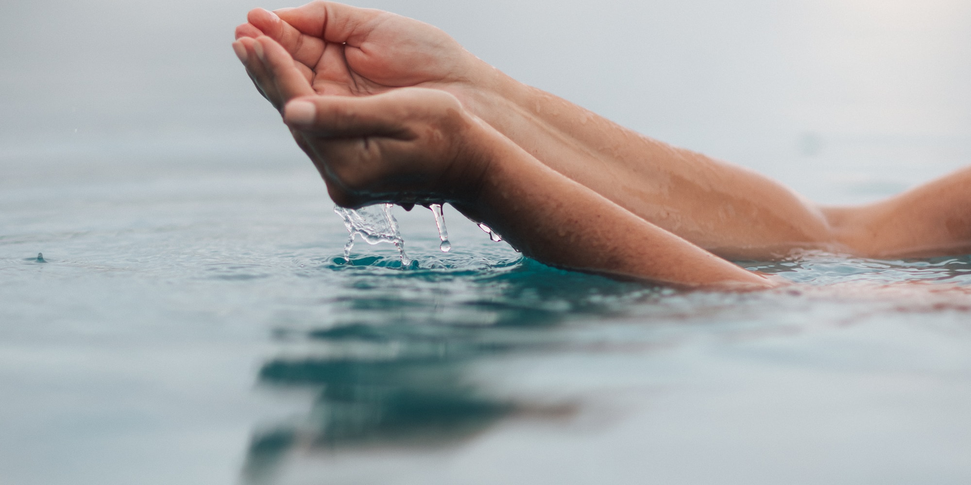 a person's hands in water