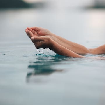 a person's hands in water