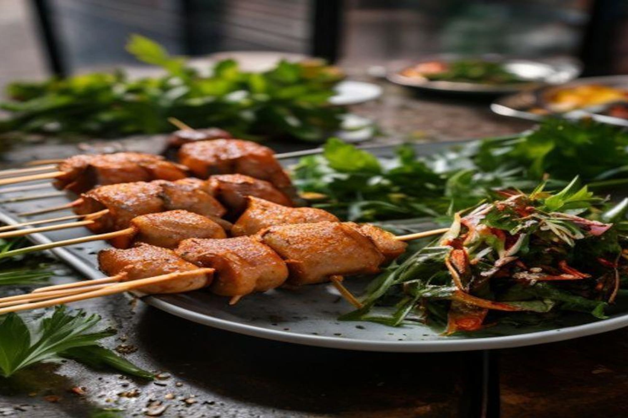 Grilled chicken skewers with fresh herbs and mixed green salad.