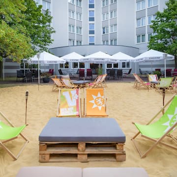 a group of chairs in a sand area