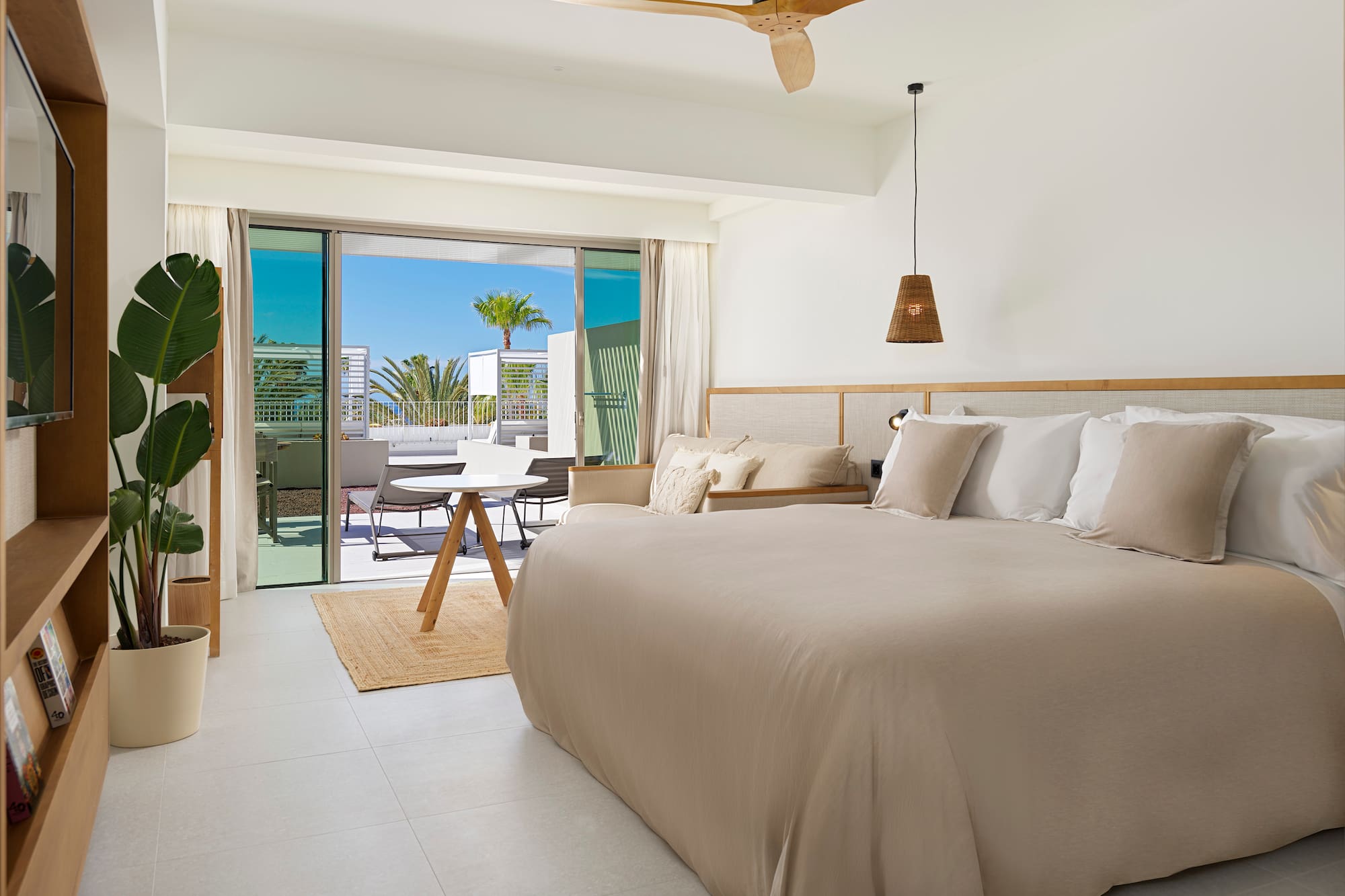 a bedroom with a bed and a ceiling fan