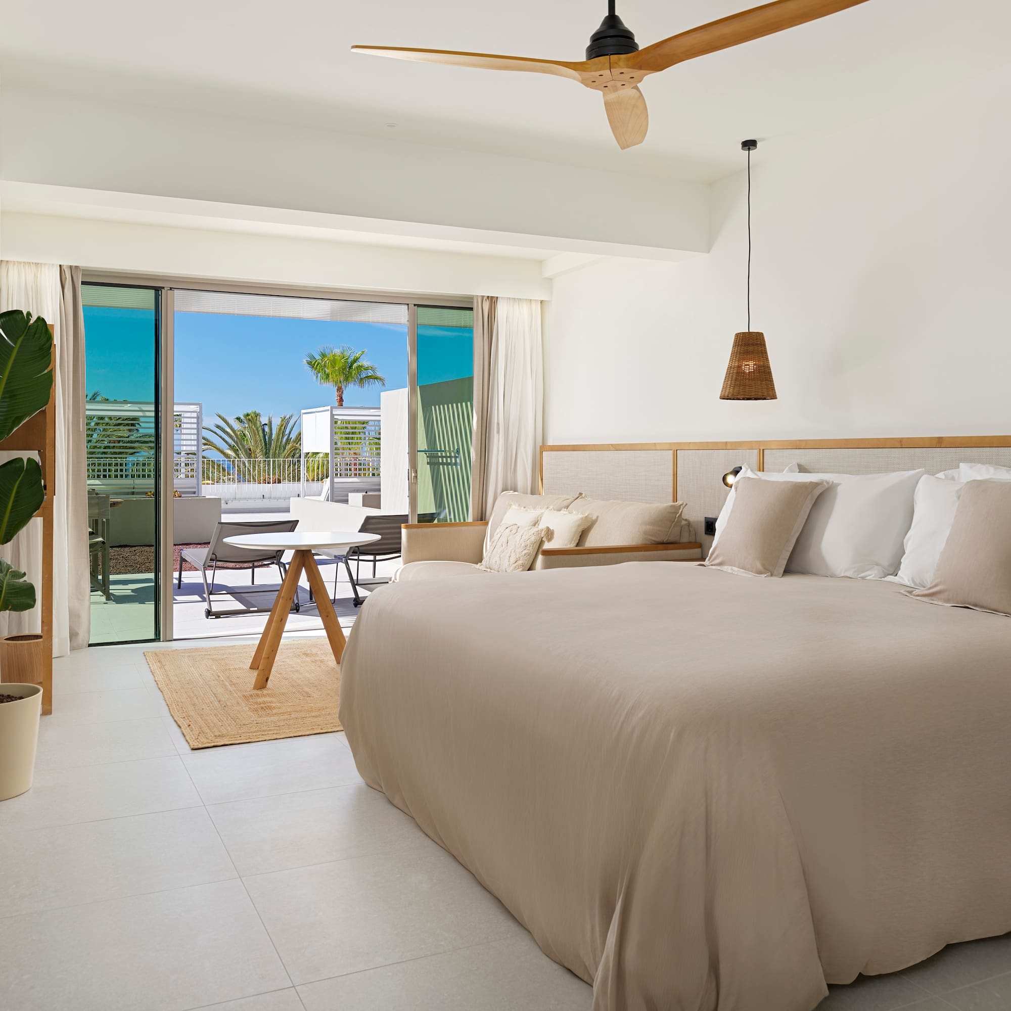 a bedroom with a bed and a ceiling fan