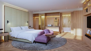 a bedroom with a bed and a round table