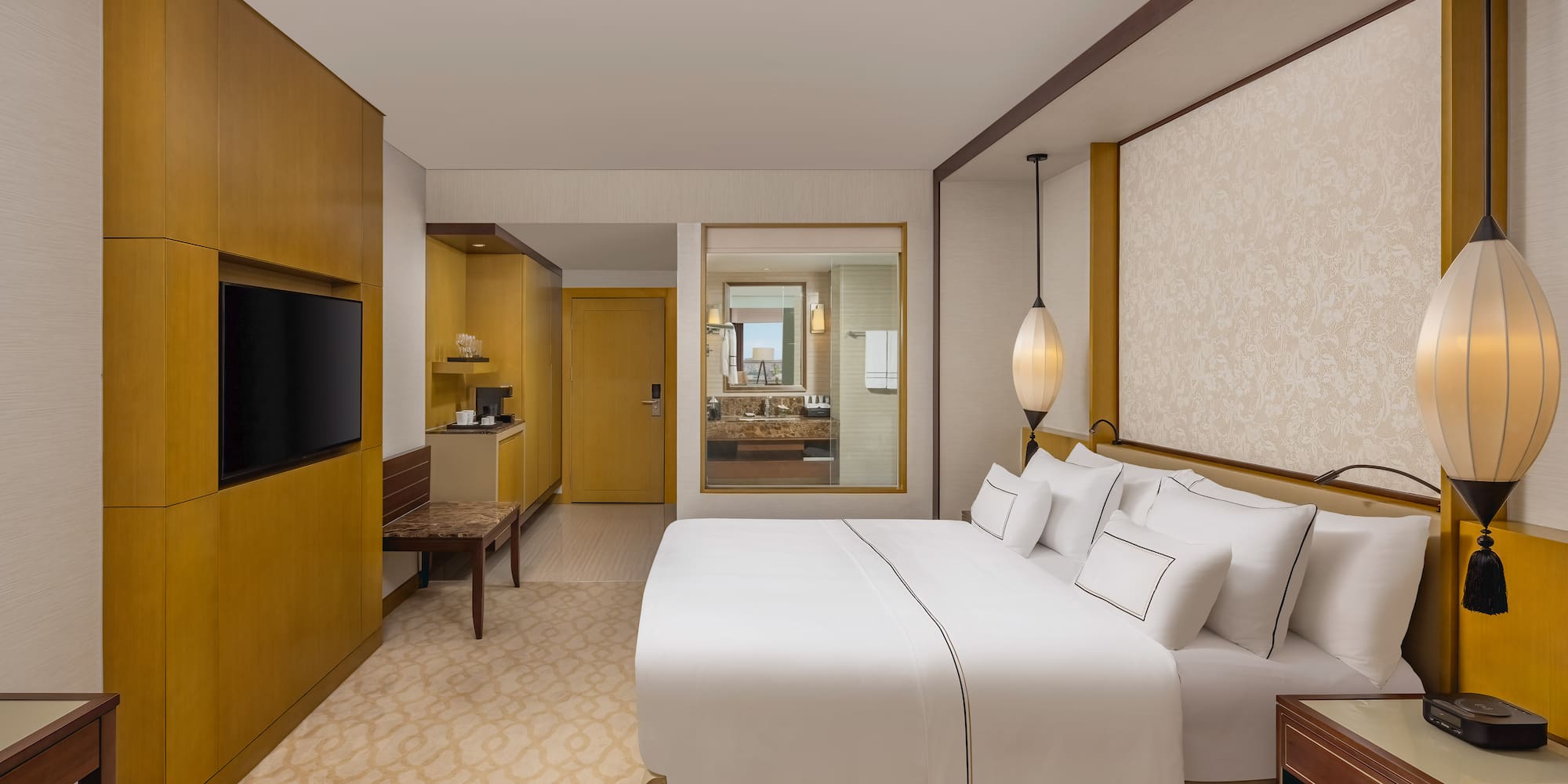 a room with a bed and a television