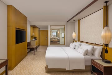 a room with a bed and a television