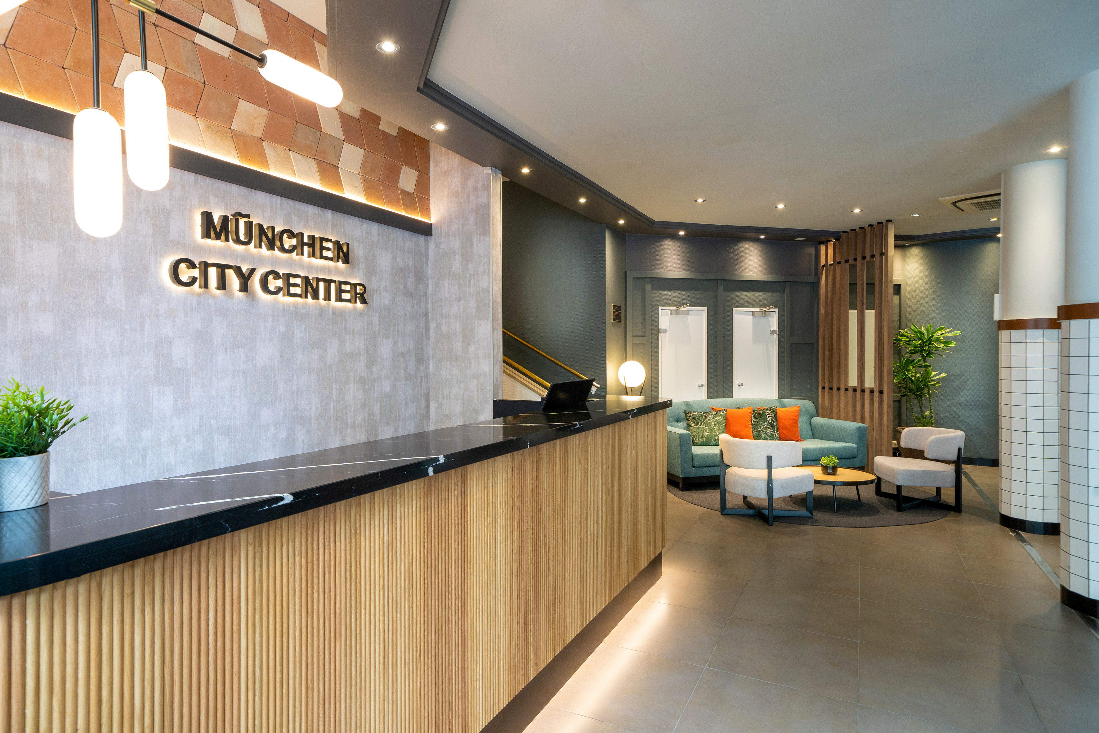 a lobby with a reception desk and chairs