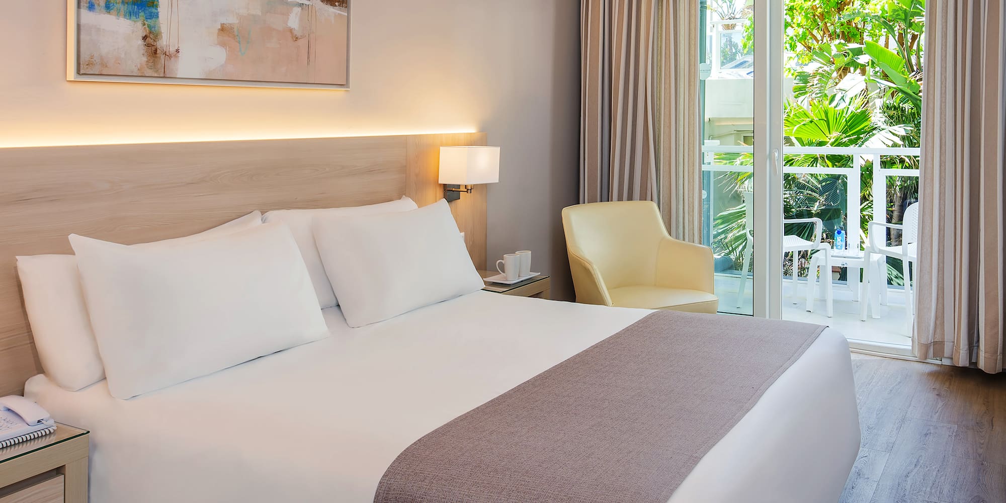 a bed with a glass door and a chair