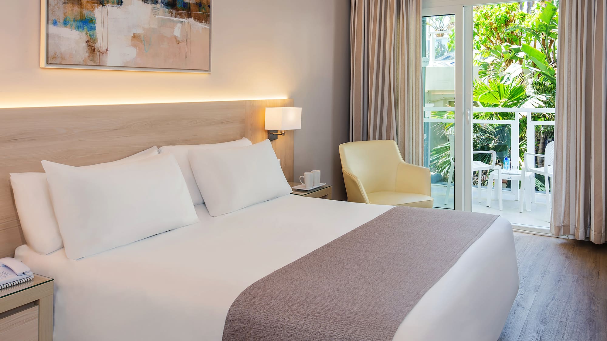 a bed with a glass door and a chair