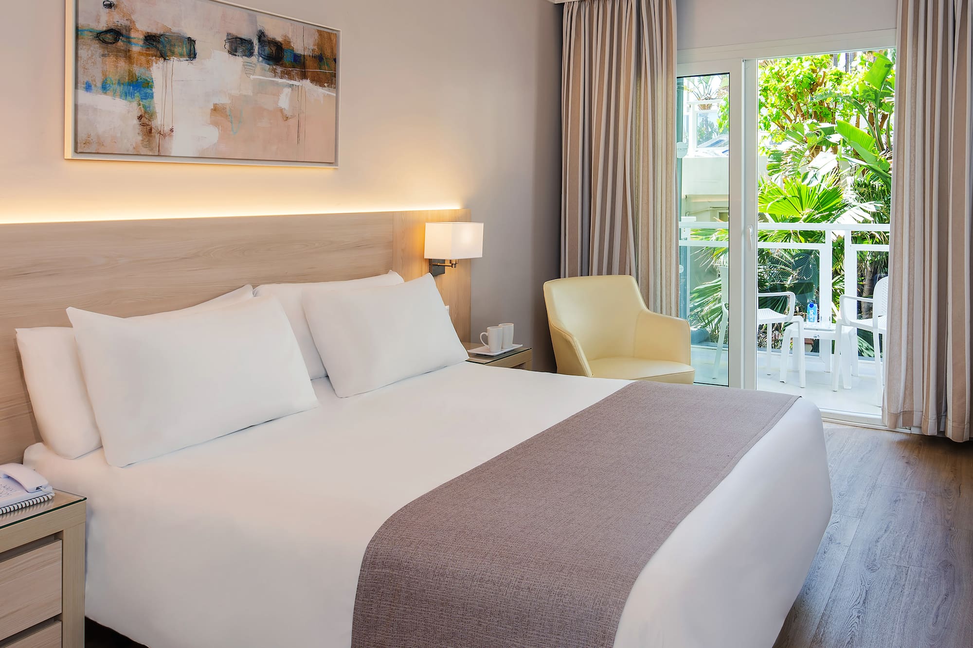 a bed with a glass door and a chair