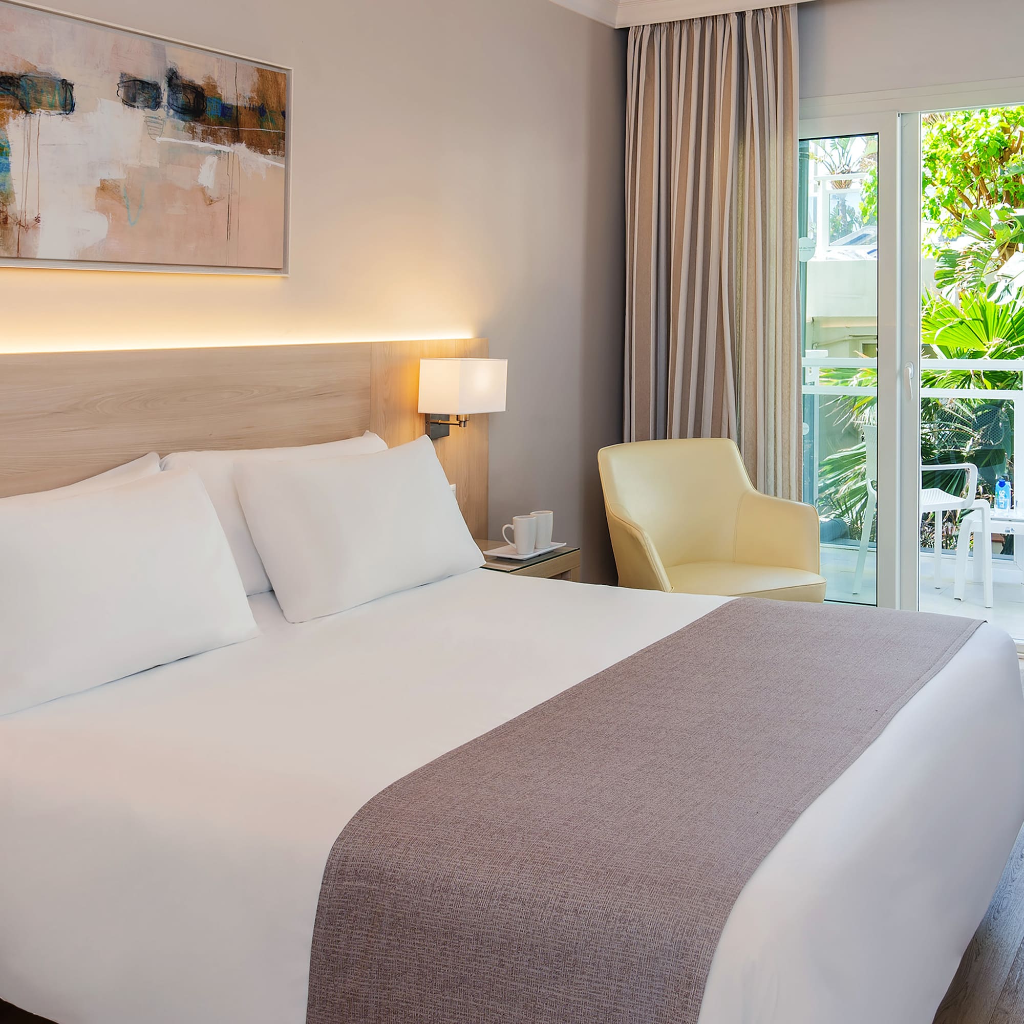 a bed with a glass door and a chair