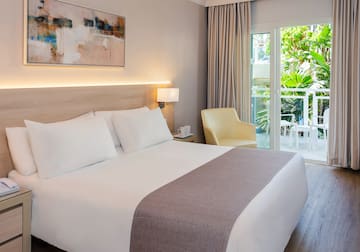 a bed with a glass door and a chair